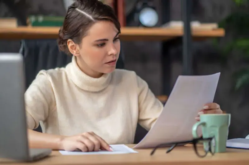 Focused professional examining documentation at a desk