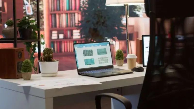 Home office desk with documents and a laptop for managing a rental