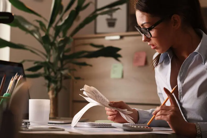Accountant reviewing tax filings and invoices for the annual closing